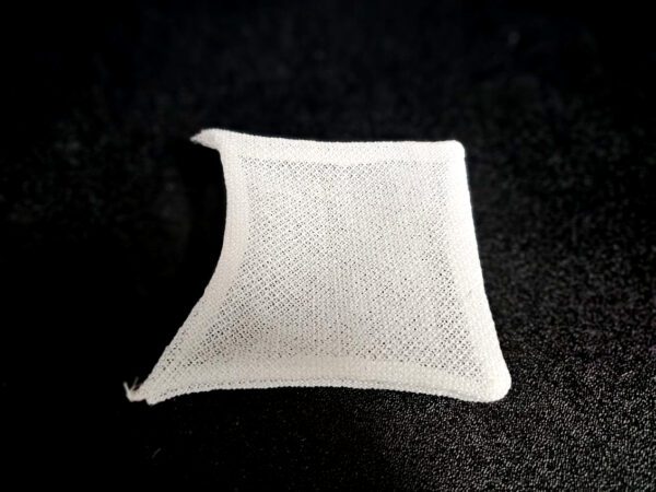 A white, porous, square-shaped FF-5 for 5/8″ (1.58 CM) TO 1-1/4″ (3.2 CM) sits against a black background.