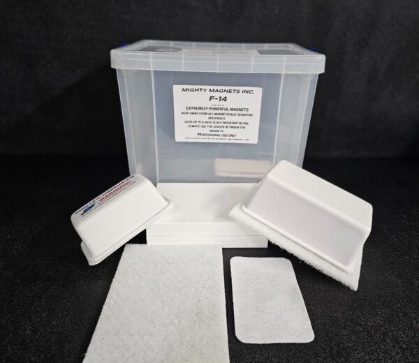 A clear plastic container labeled "F-9 1-3/4″ (4.4 cm) to 2-1/4″ (5.7 cm)" with two white foam pieces, two white rectangular pads, and a white fabric pad placed in front of it.