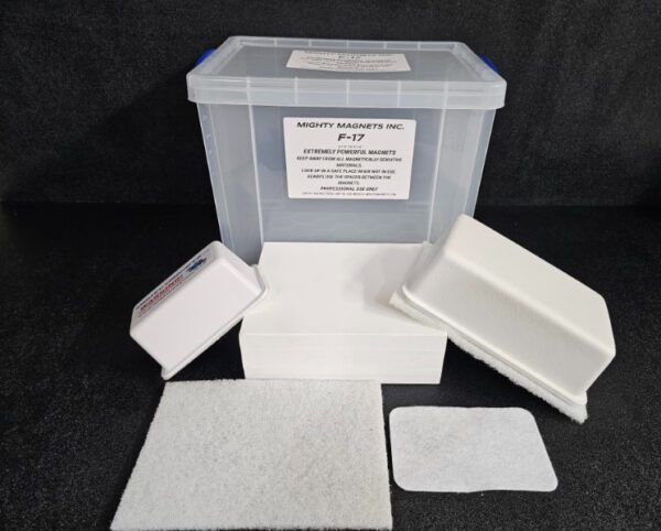 A clear plastic container labeled "F-9 1-3/4″ (4.4 cm) to 2-1/4″ (5.7 cm)" is surrounded by white foam pads and other packing materials. A white box is positioned in front of the container.