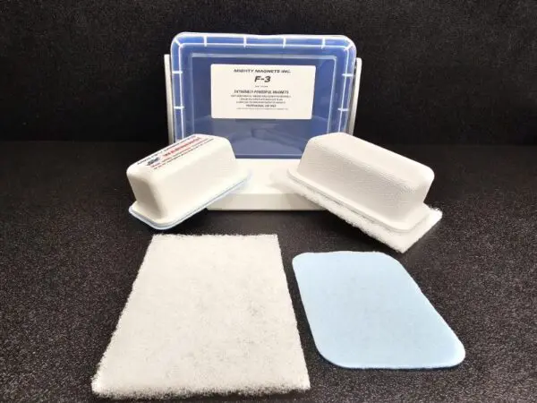 The F-2 for 1/4″ (.65cm) to 1/2″ (1.27cm) with two white rectangular abrasive pads, one white and one blue cleaning pad, and a labeled plastic container with a blue lid.