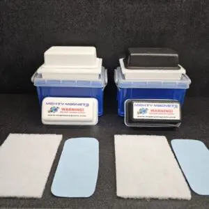 Two F-4 for 1/2″ (1.3 cm) to 1″ (2.5 cm) in plastic containers are shown, one with a white base and one with a black base. In front of each container are two white rectangular and one blue rectangular pad.