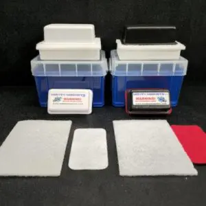 Two F-6 for 1″ (2.5 cm) to 1-1/2″ (3.8 cm) in transparent blue cases, one with a white lid and the other with a black lid, shown with multiple rectangular cleaning cloths placed in front of them.