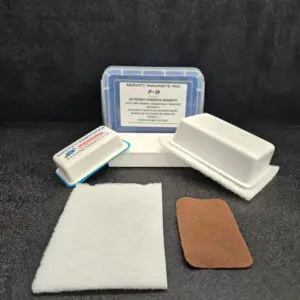 A set of extremely powerful magnets from "Mighty Magnets Inc." F-9 1-3/4″ (4.4 cm) to 2-1/4″ (5.7 cm), displayed with packaging, adhesive pads, and felt covering on a dark surface.