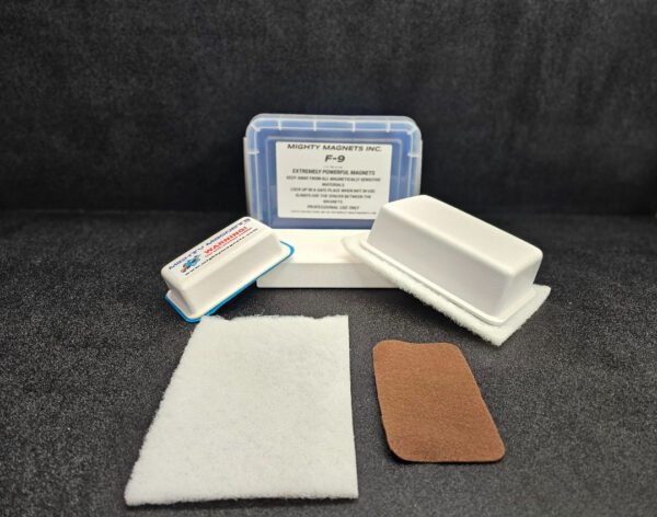 A set of extremely powerful magnets from "Mighty Magnets Inc." F-9 1-3/4″ (4.4 cm) to 2-1/4″ (5.7 cm), displayed with packaging, adhesive pads, and felt covering on a dark surface.