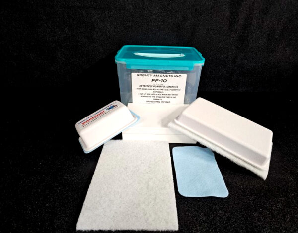 A blue-lidded plastic container labeled "FF-5 for 5/8″ (1.58 CM) TO 1-1/4″ (3.2 CM)" is accompanied by various cleaning pads and a small blue cloth, laid out on a dark surface.