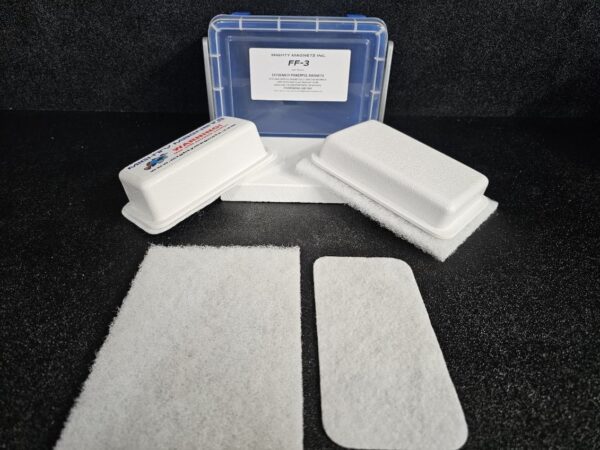 Image of two foam inserts and three rectangular filters arranged next to a plastic box labeled "FF-3 for 3/8″ (.95 CM) TO 3/4″ (1.9 CM)" on a black surface.