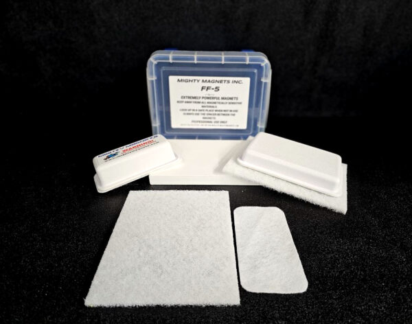 A set of white cleaning pads and a blue storage case labeled "FF-5 for 5/8″ (1.58 CM) TO 1-1/4″ (3.2 CM)" with additional text underneath displayed on a black surface.