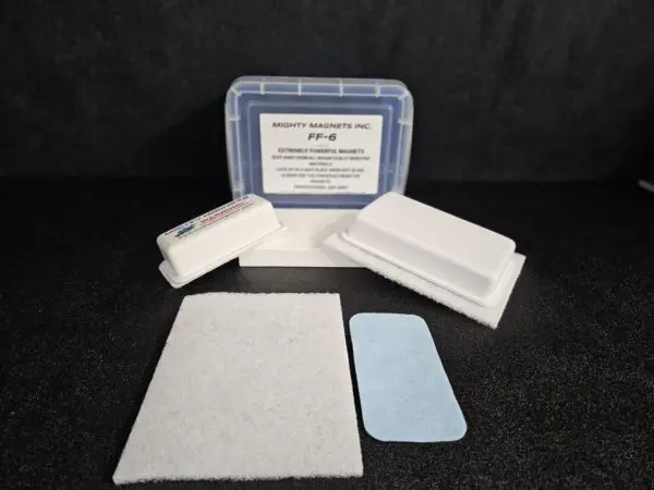 A set of FF-5 for 5/8″ (1.58 CM) TO 1-1/4″ (3.2 CM) by Mighty Magnets Inc., displayed with its packaging, various-sized foam pads, and a blue rectangular felt piece, all set against a black background.