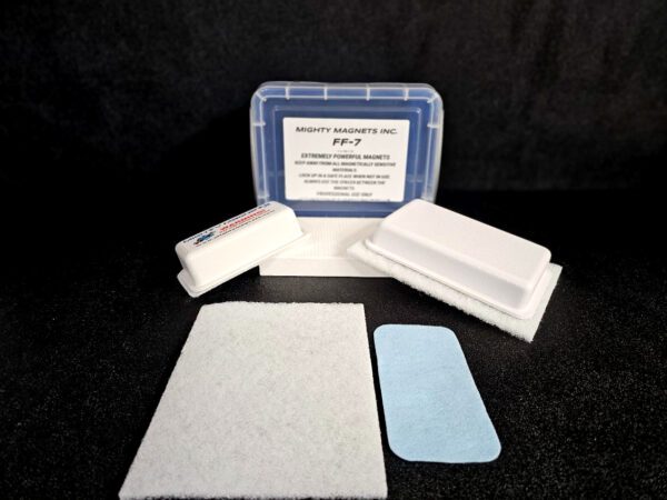 A set of cleaning pads and a blue rectangular box labeled "FF-5 for 5/8″ (1.58 CM) TO 1-1/4″ (3.2 CM)." The kit includes white foam pads and a blue adhesive pad, all displayed on a black surface.