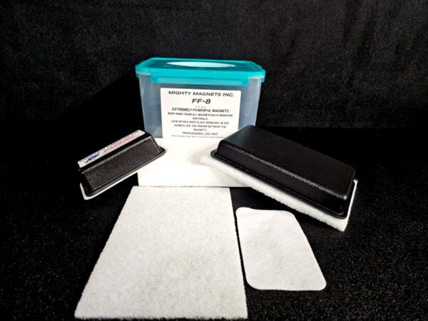 A set of magnetic cleaning pads and a rectangular container with a blue lid labeled "FF-5 for 5/8″ (1.58 CM) TO 1-1/4″ (3.2 CM)" against a black background.