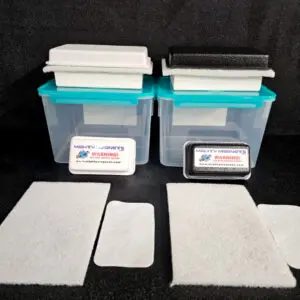 Two blue plastic containers with white and black foam pads on top. Each container has a labeled warning sign. Additionally, two rectangular and two square foam pieces are placed in front of the containers. Product Name: FF-5 for 5/8″ (1.58 CM) TO 1-1/4″ (3.2 CM).