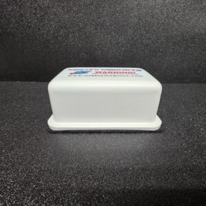 White rectangular object on dark textured background.