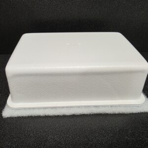 White rectangular block on dark background.