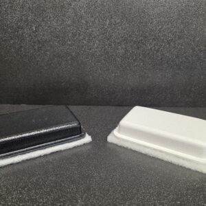 Black and white rectangular cleaning pads.