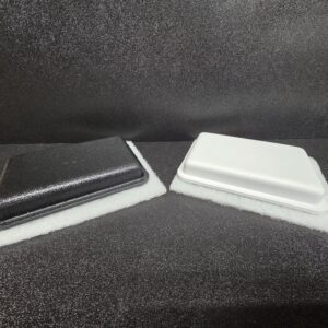 Black and white styrofoam containers on display.