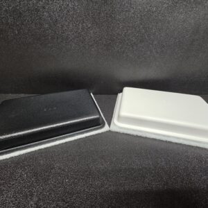 Black and white closed boxes on surface.